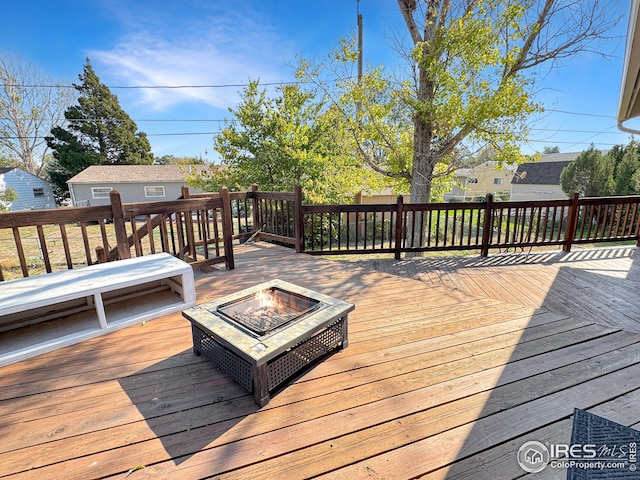 wooden terrace with an outdoor fire pit