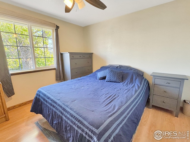 bedroom with ceiling fan and light hardwood / wood-style flooring