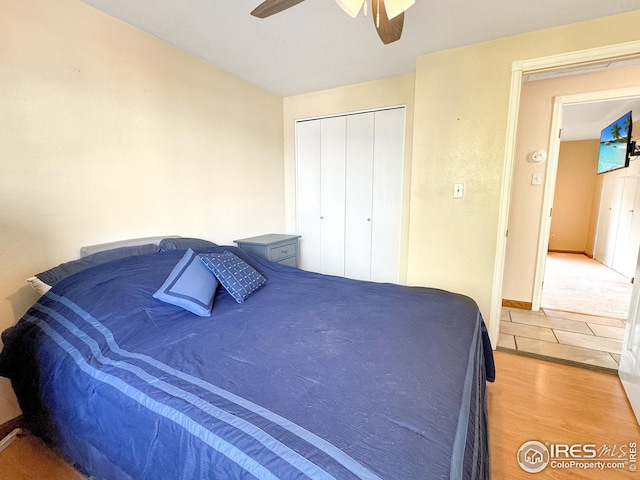 bedroom featuring a closet, hardwood / wood-style floors, and ceiling fan