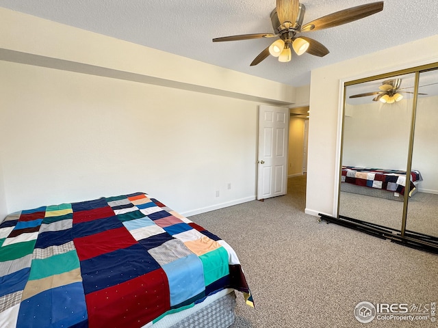 bedroom featuring carpet floors, a closet, a textured ceiling, and ceiling fan