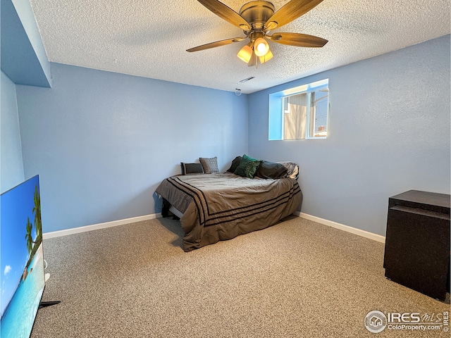 carpeted bedroom with a textured ceiling and ceiling fan