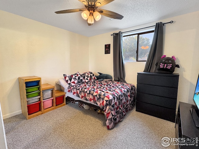 carpeted bedroom featuring a textured ceiling and ceiling fan