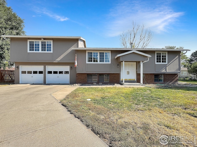 bi-level home with a garage and a front yard