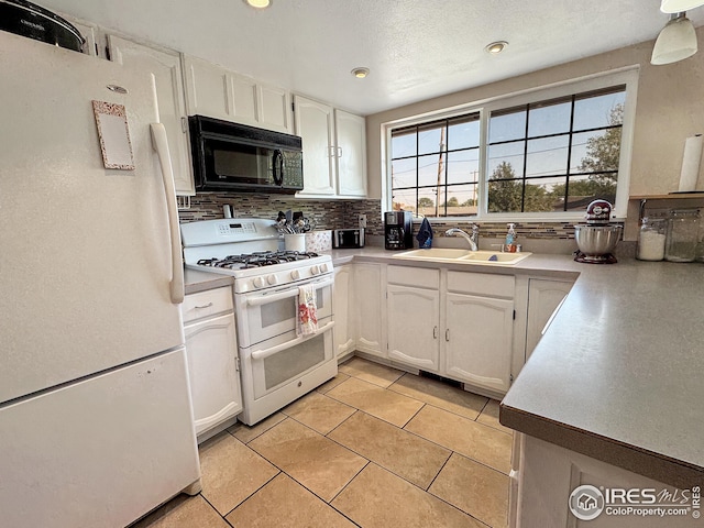 kitchen featuring light tile patterned floors, tasteful backsplash, sink, white appliances, and white cabinetry