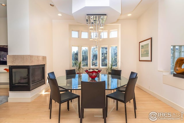 dining room featuring recessed lighting, wood finished floors, and a notable chandelier