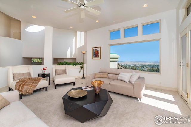 living room featuring recessed lighting, a high ceiling, carpet flooring, and ceiling fan