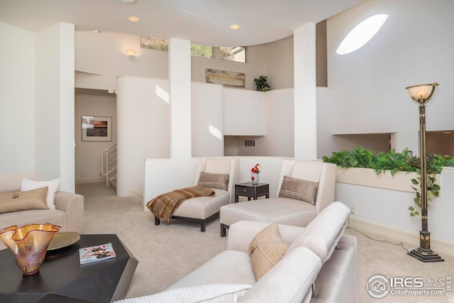 living area with baseboards and carpet flooring