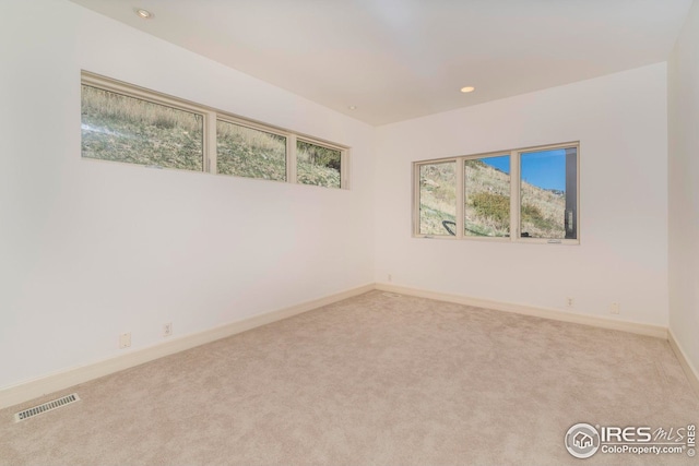 unfurnished room featuring visible vents, recessed lighting, carpet flooring, and baseboards