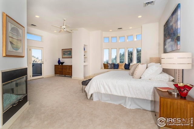carpeted bedroom with recessed lighting, visible vents, and multiple windows