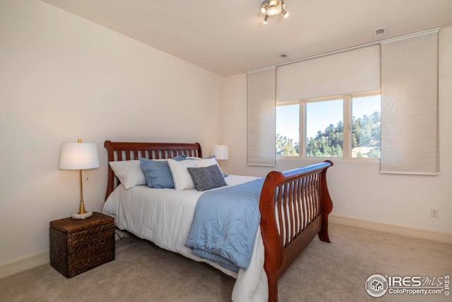 carpeted bedroom with baseboards