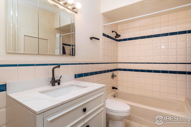 full bath featuring tile walls, toilet, shower / washtub combination, and vanity