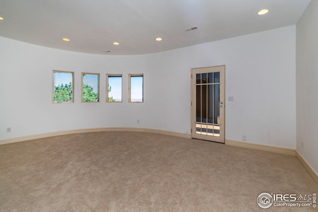 carpeted empty room with visible vents, recessed lighting, and baseboards