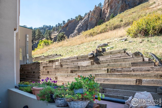 exterior details with a mountain view, fence, and stucco siding