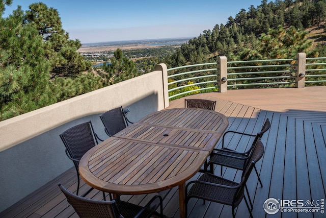 wooden deck featuring outdoor dining area