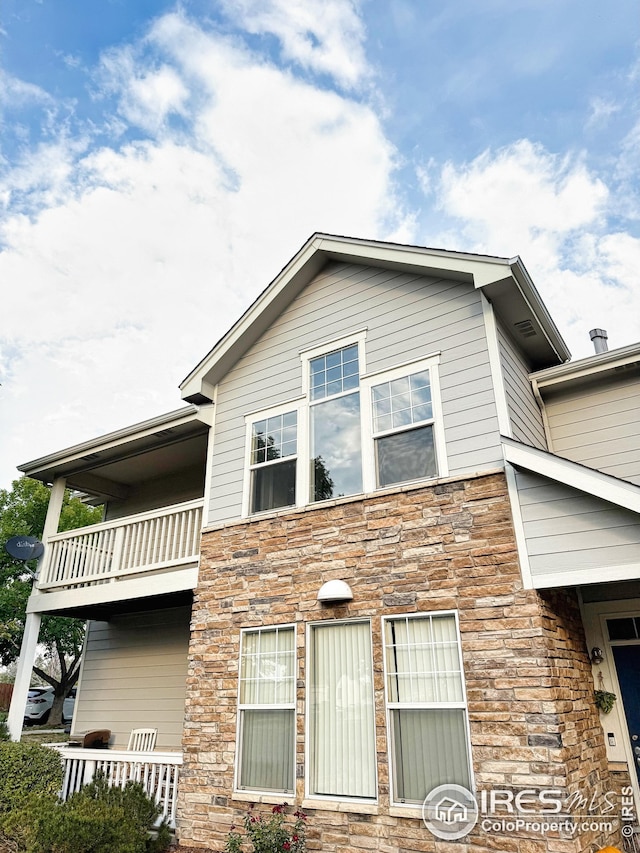 view of side of home featuring a balcony