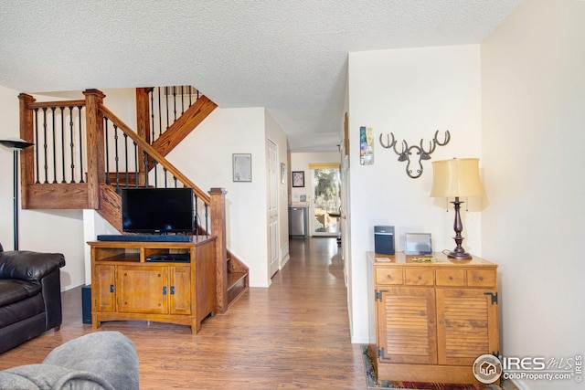 living room featuring hardwood / wood-style floors and a textured ceiling