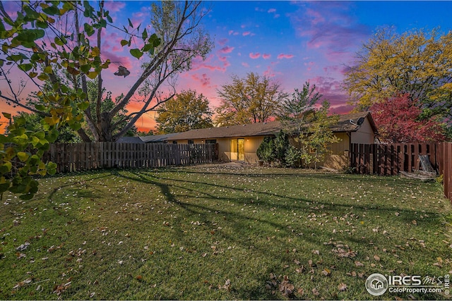 view of yard at dusk