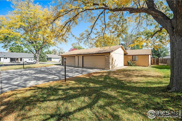 single story home featuring a garage and a front yard