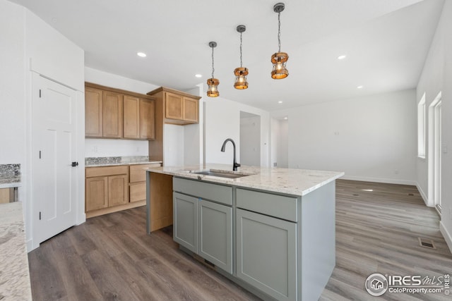 kitchen with dark wood-type flooring, recessed lighting, visible vents, and a sink