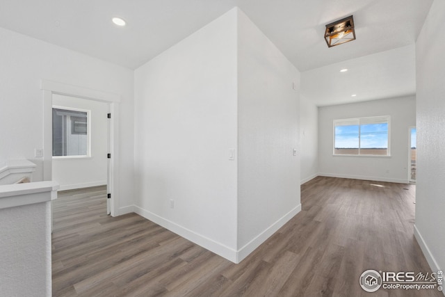 hall with recessed lighting, baseboards, and wood finished floors