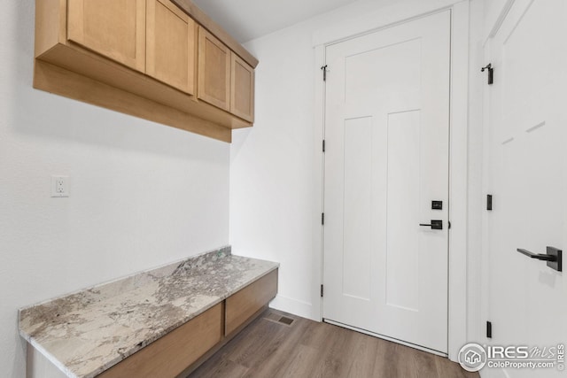 mudroom with baseboards and wood finished floors