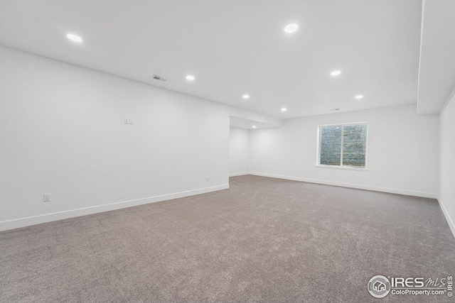 carpeted empty room with recessed lighting, visible vents, and baseboards