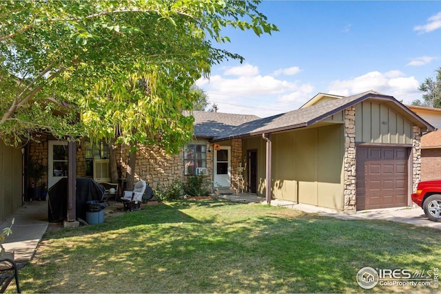 ranch-style home featuring a front yard and a garage