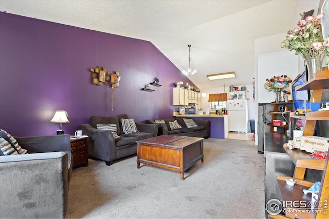 living room with light colored carpet, vaulted ceiling, and a chandelier