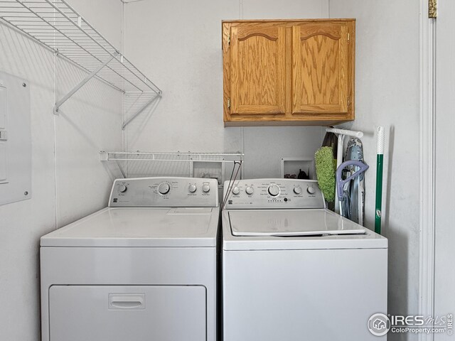 washroom with cabinet space and washing machine and clothes dryer