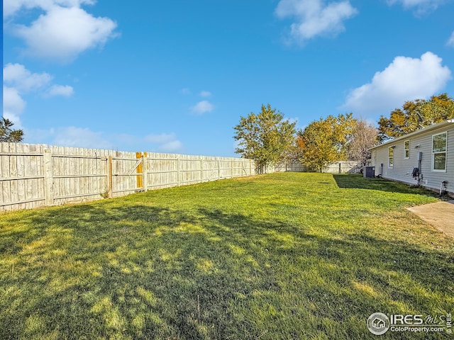 view of yard featuring cooling unit and a fenced backyard