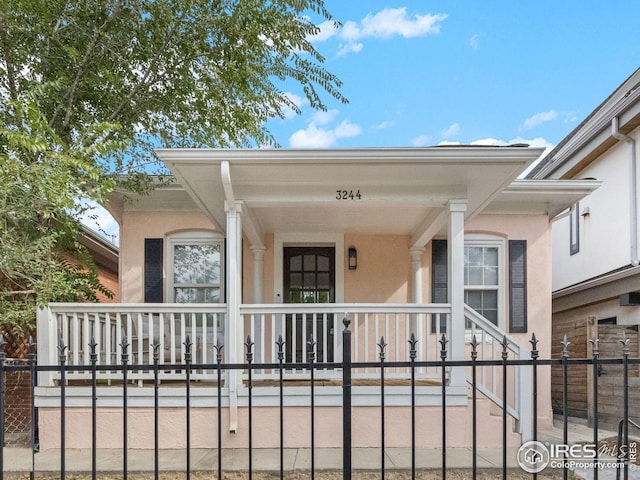 entrance to property featuring covered porch