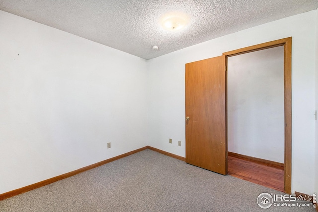 unfurnished bedroom with carpet and a textured ceiling