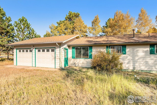 ranch-style house featuring a garage