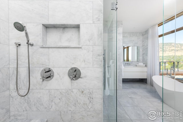 bathroom with vanity, a mountain view, separate shower and tub, and tile patterned floors