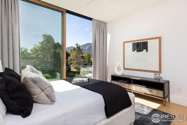 bedroom featuring a mountain view and wood-type flooring