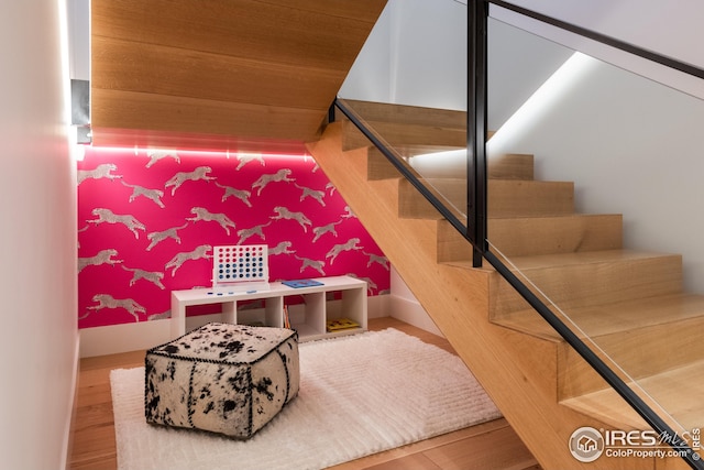 staircase with hardwood / wood-style floors and wood ceiling