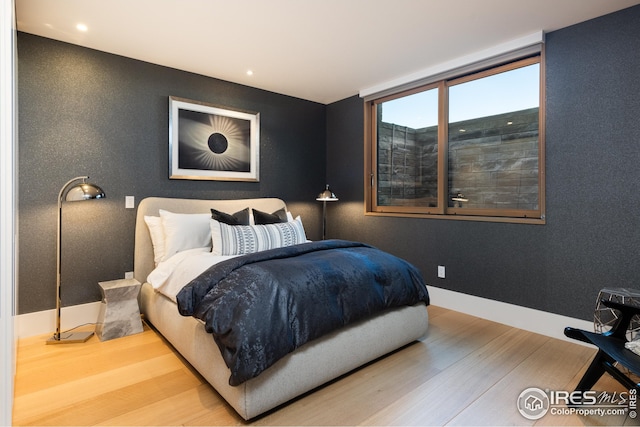 bedroom featuring hardwood / wood-style floors and floor to ceiling windows