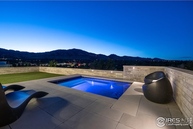 view of swimming pool featuring a mountain view, a hot tub, and a patio area