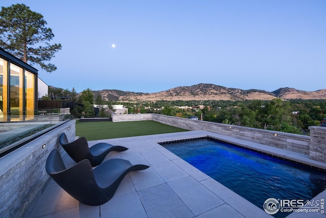 view of swimming pool with a mountain view