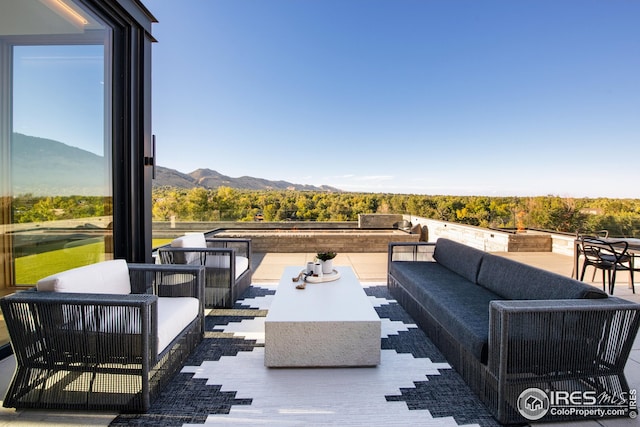 view of patio with outdoor lounge area and a mountain view