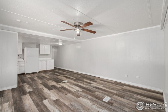 unfurnished bedroom featuring ensuite bathroom, hardwood / wood-style flooring, a closet, and white fridge