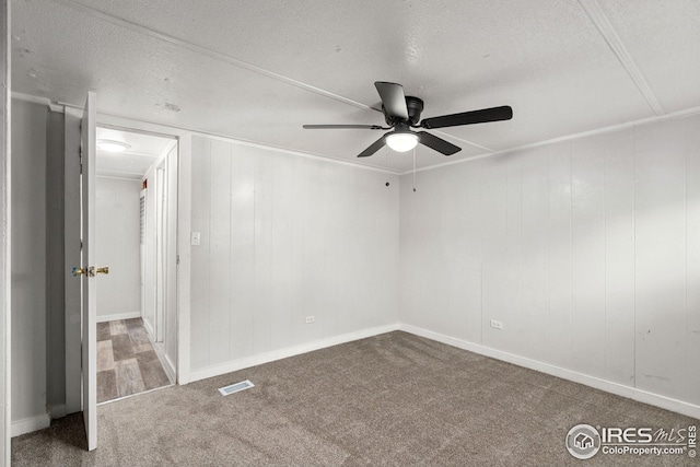 unfurnished room with carpet flooring, a textured ceiling, and ceiling fan