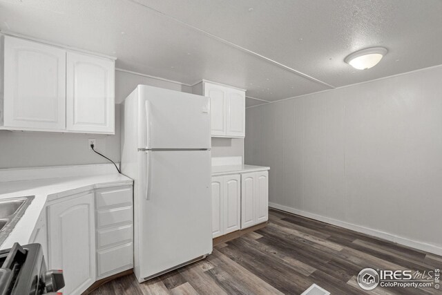 kitchen with sink, a textured ceiling, dark wood-type flooring, white cabinetry, and stainless steel range with gas cooktop