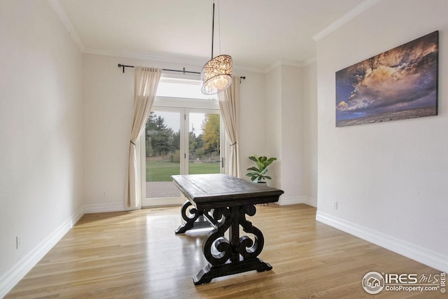 dining area with ornamental molding and light wood-type flooring