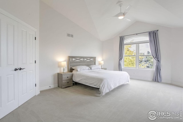 bedroom featuring light carpet, a closet, ceiling fan, and lofted ceiling