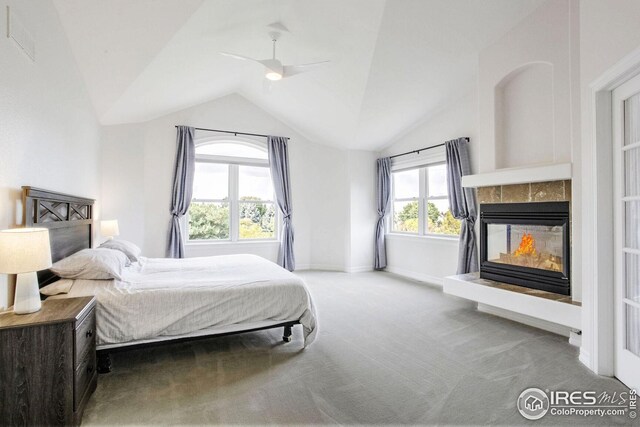 bedroom with carpet, multiple windows, lofted ceiling, and ceiling fan