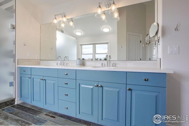 bathroom with vanity and an enclosed shower