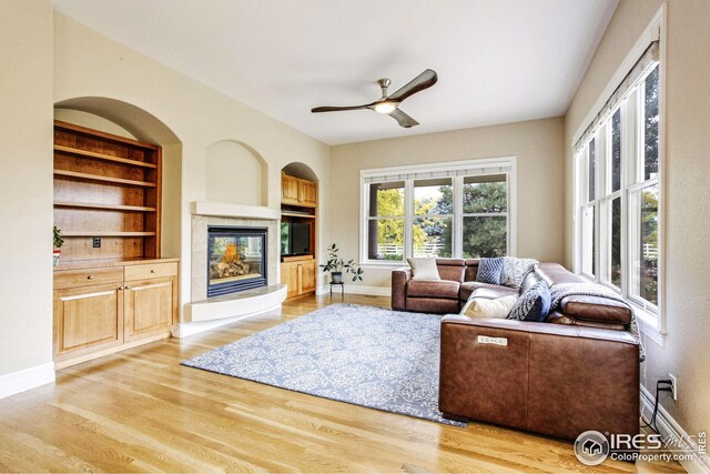 living room featuring ceiling fan and light wood-type flooring