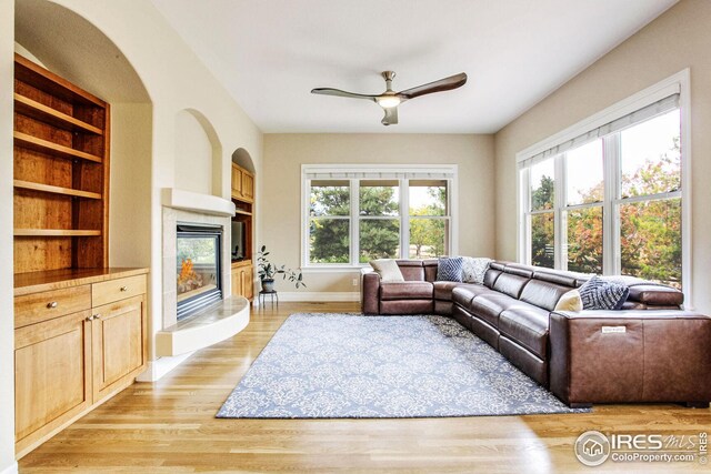 living room with ceiling fan and light hardwood / wood-style floors