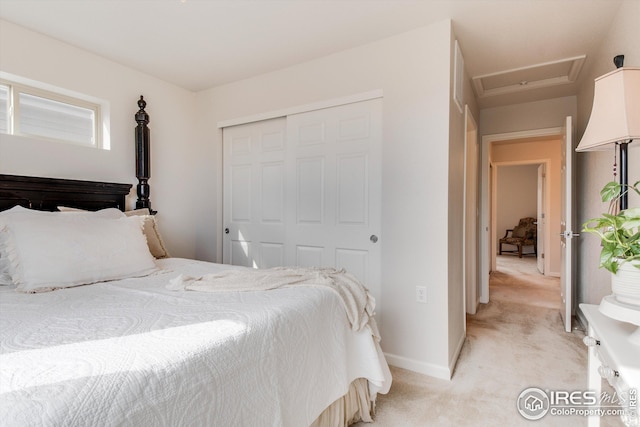 1135 Hummingbird Cir, Longmont, CO 80501 - bedroom with baseboards, light carpet, attic access, and a closet